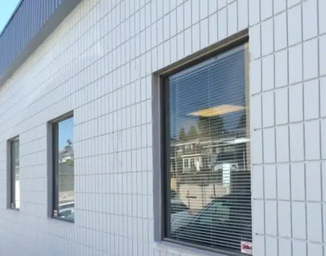 Modern building exterior with white tiled facade and windows, Vancouver AZ Painting Ltd.
